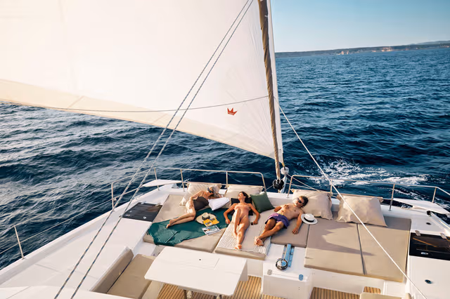 5_Group_of_people_resting_on_the_foredeck_of_the_BALI_while_sailing_86936bfb54