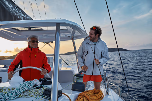 5_Two_men_maneuvering_at_the_helm_af837a212f